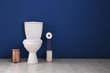 © New Africa - Simple bathroom interior with new toilet bowl near color wall. Space for text