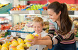 © JackF - Portrait of happy woman and her little son choosing pears and apples at shop