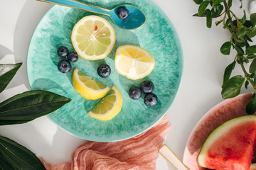 Wall Mural - Blueberries and Lemon Slices on Teal Plate