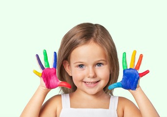 Wall Mural - Cute little girl with colorful painted hands on  background