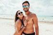 Young couple having fun on tropical beach