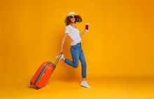 Concept Of Travel. Happy Woman Girl With Suitcase And  Passport On  Yellow Background.
