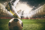 Fototapeta Sport - Close up of a soccer striker ready to kicks the ball at the stadium