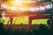 © alphaspirit - Football scene at night match with with cheering fans at the stadium