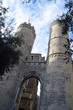 Porta Soprana city ancient gates, stone towers of genoa in italy, flags