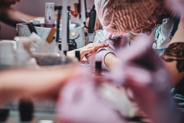 Wall Mural - Very busy manicure studio with a lot of working staff and clients.