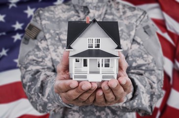 Canvas Print - Soldier Holding a Model of House