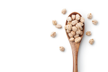 Dry chickpeas in a wooden spoon isolated on white background. Top view.