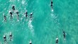 Aerial photo of a swimmers in open water swimming competition in turquoise sea