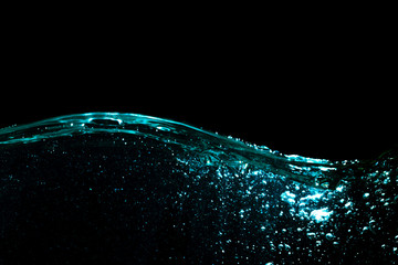 Wall Mural - Water Wave. Water Surface with Ripple and Bubbles on Black Background.	