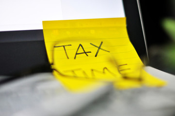 Tax Season: Horizontal top right view of an office laptop background with an eye glasses preparation on taxation