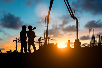 Silhouette of engineer and construction team working at site over blurred background for industry background with Light fair.Create from multiple reference images together