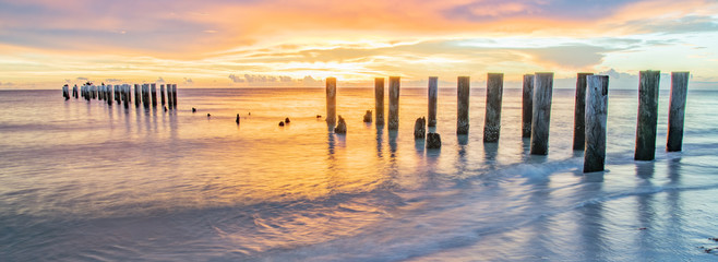 pier at sunset at wonderful Naples Pier beach