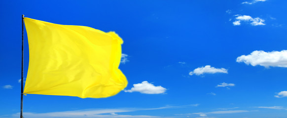 Wall Mural - Conceptual image of waving blank yellow flag over sunny blue sky