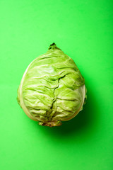 Wall Mural - Fresh cabbage head on green background