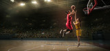 Female basketball players fight for the ball. Basketball player makes slam dunk on big professional arena during the game