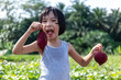 Leinwandbild Motiv Asian Chinese Little Girl holding purple potato in organic farm