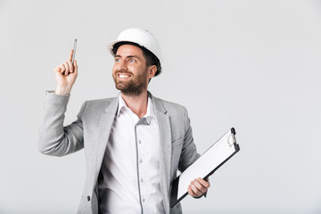 Confident bearded man builder wearing suit