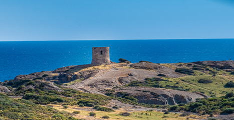 Catalan defense tower along the spectacular coastal road between Alghero and Bossa (SP 105), Sardinia, Italy. One of the most panoramic spots in Italy.