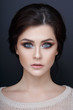 © Dragosh - Close up portrait of a beautyful girl with perfect makeup. Face of a beautiful girl, isolated on a gray background.