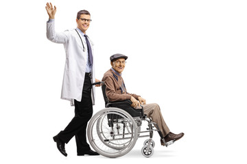 Canvas Print - Young male doctor waving and pushing an elderly male patient in a wheelchair