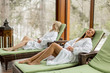 © BGStock72 - Young women relaxing on the deckchair by the swimming pool in spa