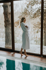 Wall Mural - Pretty woman in bathrobe.standing  by the pool in the spa