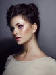 © Dragosh - Natural beauty portrait of a girl with shiny perfect make-up, with arranged hair, isolated on a grey background.