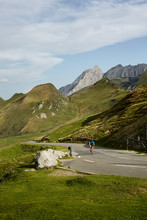Male Cyclist Going Uphill On A Mountain Road