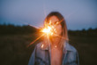 © Sergey Filimonov/Stocksy - Unrecognizable woman with sparkler