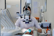© Danil Nevsky/Stocksy - Dentist looking at equipment during surgery