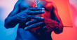 © Luis Velasco/Stocksy - Portrait Of A Man Under Blue And Red Lights.