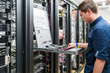 © Westend61 - Teenager working in server room