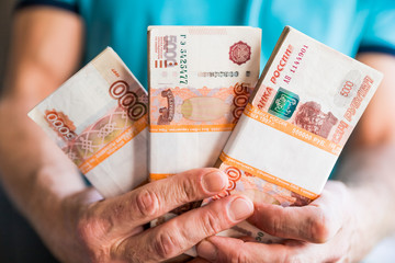 Denominations of five thousand russian rubles. Bundle of banknotes isolated in male hand.5000 rubles. five thousand cash of the Russian Federation macro Russian currency.Rich concept