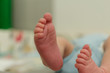 © Mario - Close up of bare feet of newborn baby.