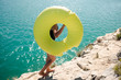 © L?a Jones/Stocksy - teen girl carrying a yellow float