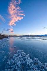 Wall Mural - Winter Lake - Vertical - Light sunset clouds over a blue icy cold winter lake. Chatfield State Park, Denver-Littleton, Colorado, USA.