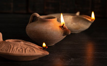 Lit Handmade Oil Lamp From The Middle East On A Dark Table
