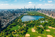 Central Park Aerial View, Manhattan, New York. Park Is Surrounded By Skyscraper. Beautiful View Of The Jacqueline Kennedy Onassis Reservoir In The Center Of The Park.
