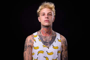 Wall Mural - Young handsome rebellious man with blond hair and tattoos