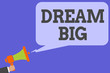 Writing note showing Dream Big. Business photo showcasing To think of something high value that you want to achieve Man hold Megaphone loudspeaker computer screen talking speech bubble