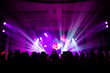 © NVB Stocker - Defocused entertainment concert lighting on stage with people silhouette