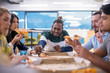 © .shock - multiethnic business team eating pizza