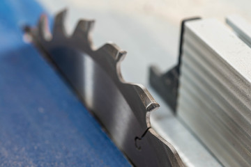 Wall Mural - Table saw blade tooth close up macro shot , image for industrial background.