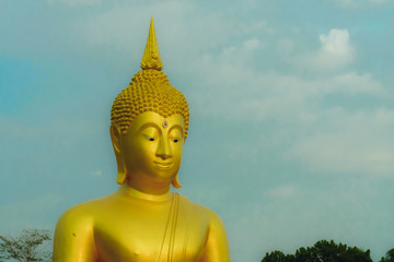 Golden buddha statue with beautiful sky