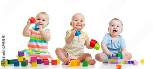 Nursery babies playing with toys isolated on white background