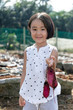 Leinwandbild Motiv Asian Chinese Little Girl holding purple potato in organic farm