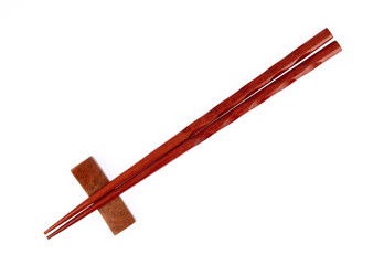 pair of wood chopsticks with wood holder isolated on a white background