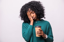 Tired Sleepy African Woman Covers Half Of Face With Palm, Has Sad Expression, Closes Eyes, Carries Disposable Cup Of Drink Containing Caffeine, Has Continue Working Isolated On White Background