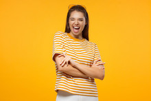 Pretty Girl Smiling And Winking, Looking At Camera, Isolated On Yellow Background
